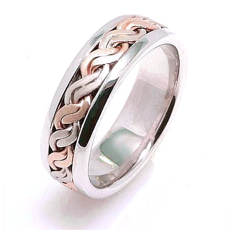 Item # 221709E - 18 K white and rose gold, comfort fit, 7.0 mm wide, hand made wedding band. There is a hand crafted braided rope in the center. The finish in the center is matte and the outer edges are polished. Different finishes may be selected or specified.