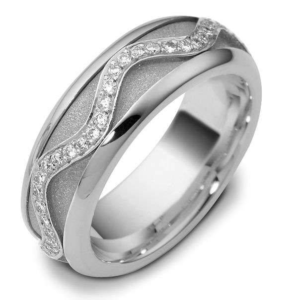 Item # 47769WE - 18kt White gold diamond, comfort fit, spinning, 7.0mm wide wedding band. The ring has approximately 0.30 ct tw diamonds, VS1-2 in clarity and G-H in color. There are about 60 round brilliant cut diamonds all around the band. The quantity and total weight of diamonds may vary depending on the size of the ring. The center of the ring spins. It is 7.0mm wide and comfort fit. The center of the band has a sandblast finish. 