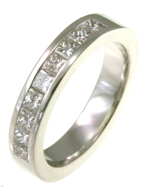 Item # 521409WE - 18Kt White gold anniversary band. The ring holds 9 princess cut diamonds each measures 2.5x2.5 mm in size. The diamonds are approximately 0.90 ct tw, VS1-2 in clarity, very clean and G-H in color, near colorless to colorless. The diamonds are set in a channel. The band is about 3.5 mm wide. The finish is polished. Different finishes may be selected or specified.