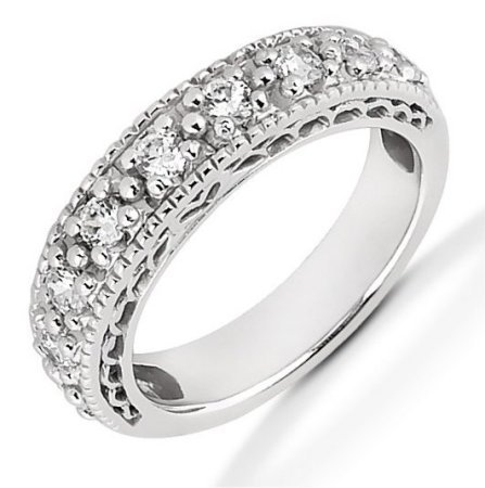 Item # 521453WE - 18Kt White gold anniversary band. The ring holds 9 round brilliant cut diamonds that measures 2.7 mm in size. The diamonds are approximately 0.63 ct tw, VS1-2 in clarity, very clean and G-H in color, near colorless to colorless. The diamonds are set in prongs. The band is about 4.0 mm wide. The finish is polished. Different finishes may be selected or specified. 