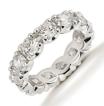 Item # 53306W - Diamond eternity ring made with 14Kt white gold. The ring holds 13 round brilliant cut diamonds each measures approximately 4.3 mm in size. The diamonds total weight is approximately 4.0 ct for size 6.0. Diamonds are graded VS1-2 in clarity and G-H in color. The band is about 5.0 mm in width. Each diamond is set in prongs and the diamonds total weight changes with ring size. The finish is polished. Different finishes may be selected.