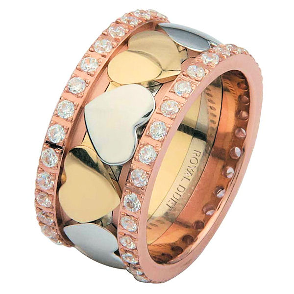 Item # 68745201D - 14 kt tri-color gold, comfort fit, 10.2 mm wide, diamond eternity ring. The band is made of white, yellow and rose gold. There are heart shapes in the center that are made of white and yellow gold. The diamonds go around the whole ring. It has approximately 1.05 ct tw round brilliant cut diamonds, that are VS1-2 in clarity and G-H in color. Diamond total weight may vary depending on the size of the ring. 
