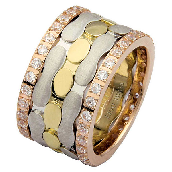 Item # 68749201D - 14 kt tri-color gold, comfort fit, 12.0 mm wide, diamond eternity ring. The band has a unique composition of white, rose, and yellow gold with diamonds accenting each side of the ring. It has approximately 1.05 ct tw round brilliant cut diamonds, that are VS1-2 in clarity and G-H in color. Diamond total weight may vary slightly depending on the size of the ring. 