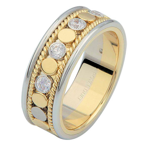 Item # 687630101DE - 18 kt two-tone gold, 6.9 mm wide, comfort fit, diamond eternity ring. The band has a beautiful combination of white and yellow gold with diamonds set in the center. There are hand crafted ropes in the ring. The ring has about 0.28 ct tw round brilliant cut diamonds, that are VS1-2 in clarity and G-H in color. 