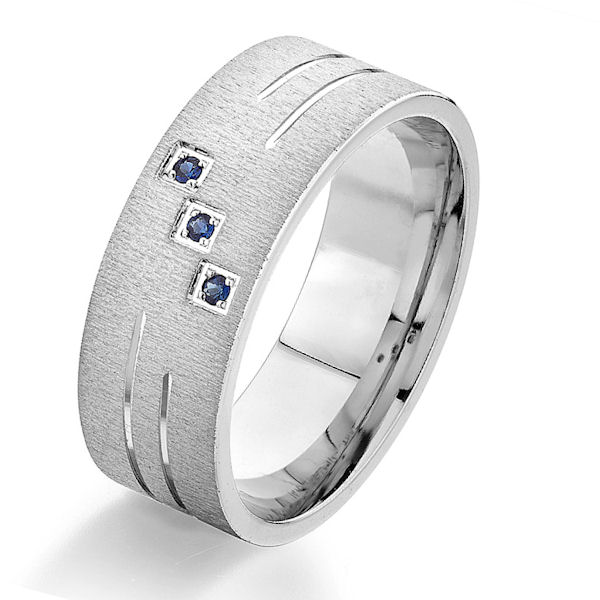 Item # G86973W - 14kt white gold, sapphire, comfort fit wedding ring. There are 3 round brilliant cut blue sapphires set in the ring. The sapphires each measure about 1.3 mm in size with a carat total weight of 0.03. The ring is 8.0 mm wide with a rough brush finish. Other finishes may be selected or specified. 