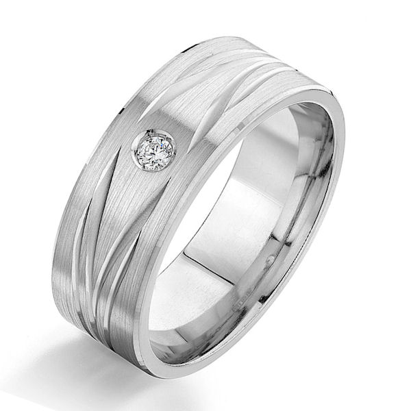 Item # G87003WE - 18kt white gold, carved, diamond, comfort fit wedding ring. There is one round brilliant cut diamond set in the ring. The diamond is 0.05 carats, VS1-2 in clarity and G-H in color. The ring is 8.0 mm wide with a brush finish. Other finishes may be selected or specified. 