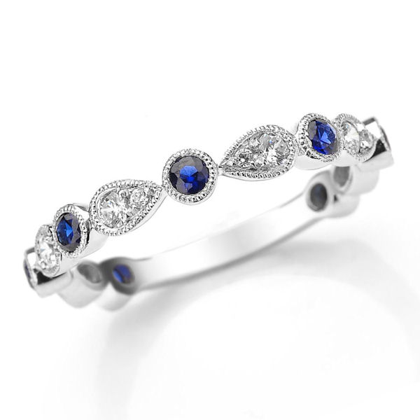 Item # M31904PP - Platinum diamond and sapphire stackable and anniversary ring. There are 13 round brilliant cut diamonds and sapphires set in the ring with milgrain designs around the stones. The diamonds are about 0.25 ct tw, VS1-2 in clarity, G-H in color and the genuine blue sapphires are about 0.40 carats. 